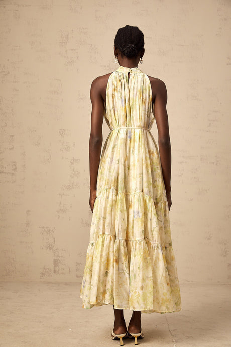 Sleeveless yellow midi dress with floral print pattern called Ulani