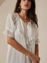 This elegant white dress features a flowing silhouette with delicate puff sleeves and intricate lace detailing. Crafted from.
