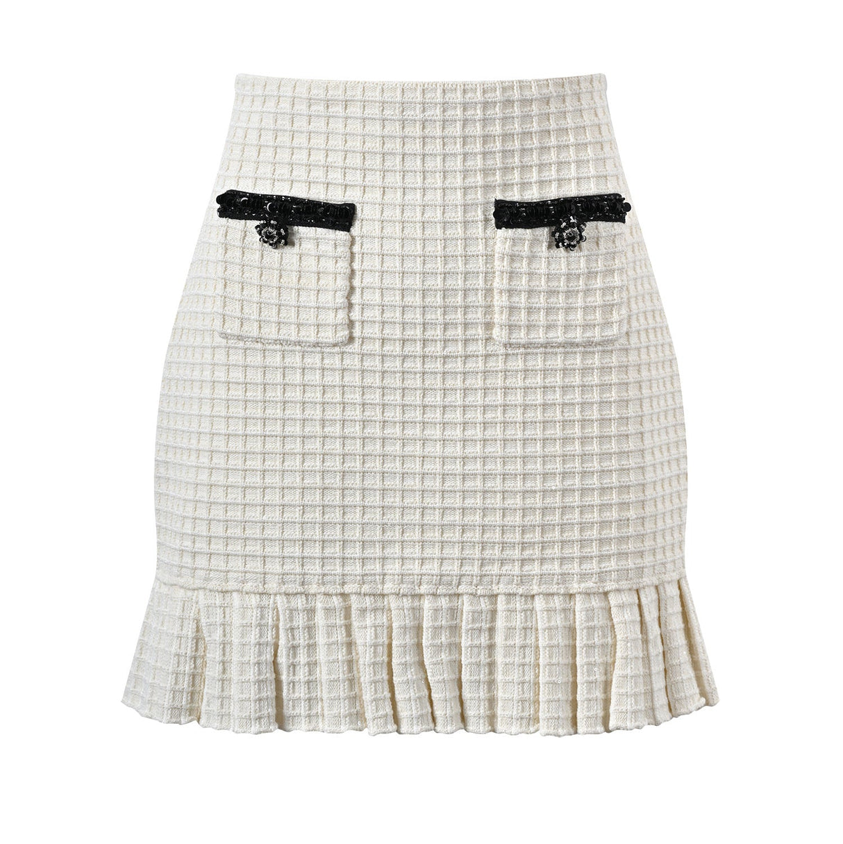 Textured white knitted jacket with black trim and decorative buttons paired with a ruffled hem skirt