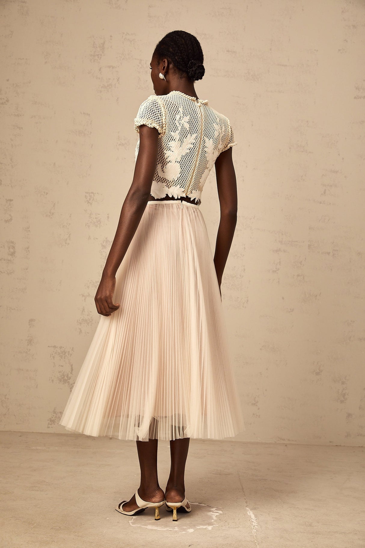 Two piece clothing set featuring floral appliques in neutral colors Top and skirt with matching fabric and design