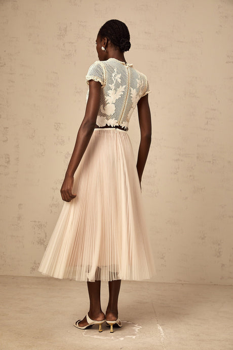 Two piece clothing set featuring floral appliques in neutral colors Top and skirt with matching fabric and design