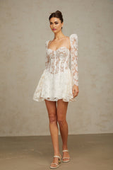 Vivienne white mini dress with floral lace pattern and corset style bodice on a plain background