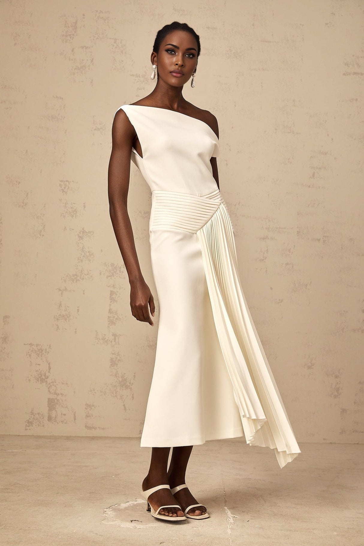 White asymmetric draped midi dress with side slit and flowing fabric