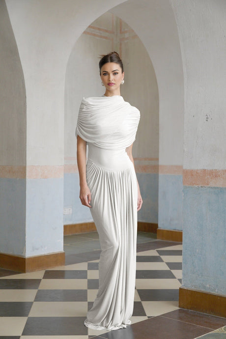 White asymmetric pleated maxi dress named Catherine on a plain background