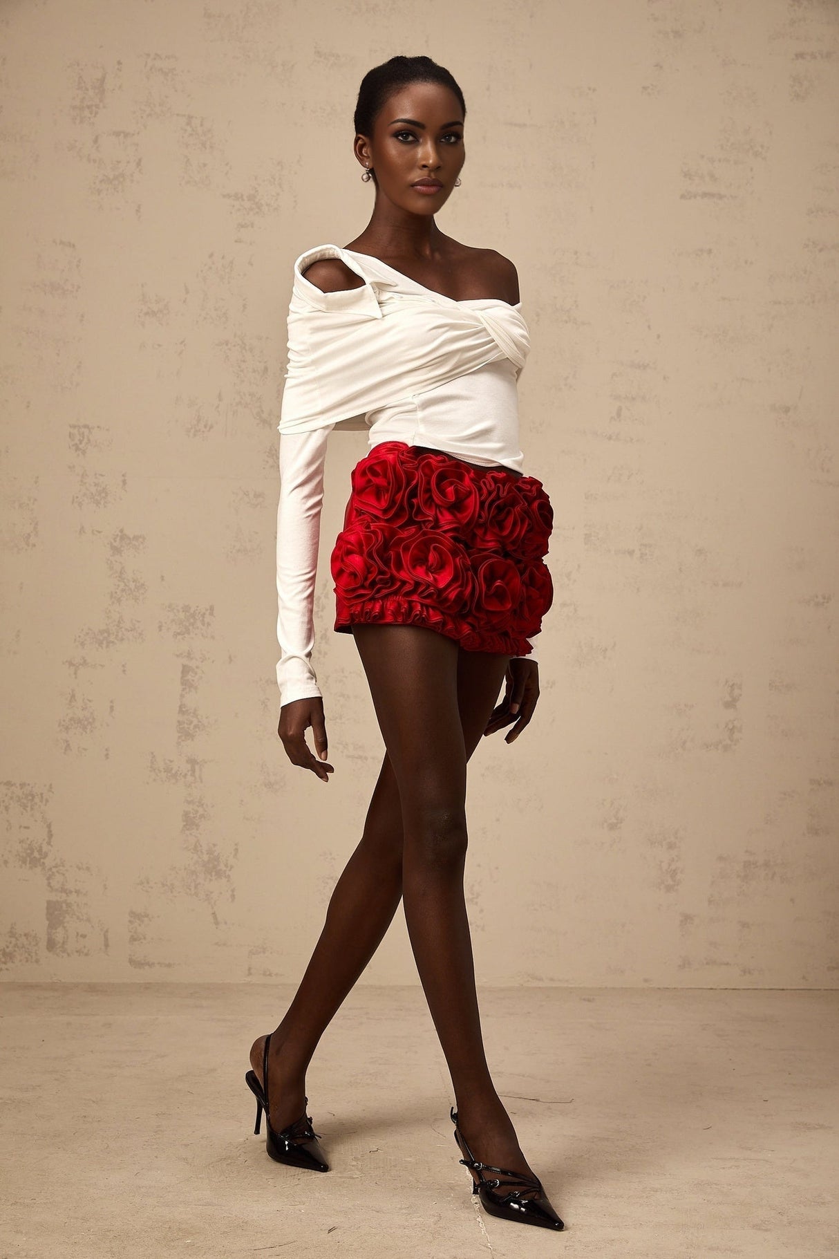 White asymmetric sleeveless top with twisted jersey fabric and draped neckline