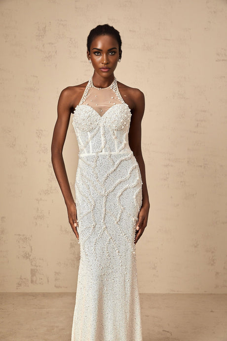 White floor length maxi dress with faux pearl embellishments and a sleeveless design