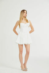 White lace corset mini dress with floral pattern and adjustable straps named Camille