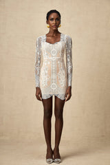White lace mini dress with scalloped hem and short sleeves on a female model
