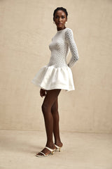 White lace mini dress with sheer panels and delicate floral pattern