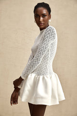 White lace mini dress with sheer panels and fitted silhouette