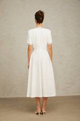 White midi dress with crystal accents and bow detail named Cassiopeia
