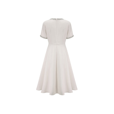 White midi dress with crystal accents and bow detail named Cassiopeia