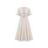 White midi dress with crystalaccented bow detail and Cassiopeia design