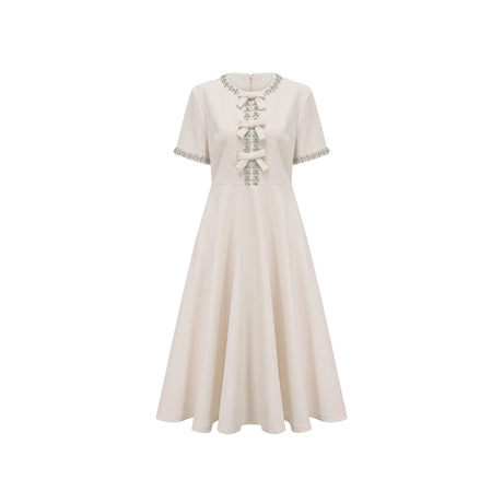 White midi dress with crystalaccented bow detail and Cassiopeia design