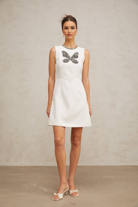White mini dress with crystal butterfly embellishments and short sleeves