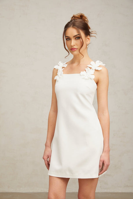 White mini dress with floral pattern featuring faux flowers
