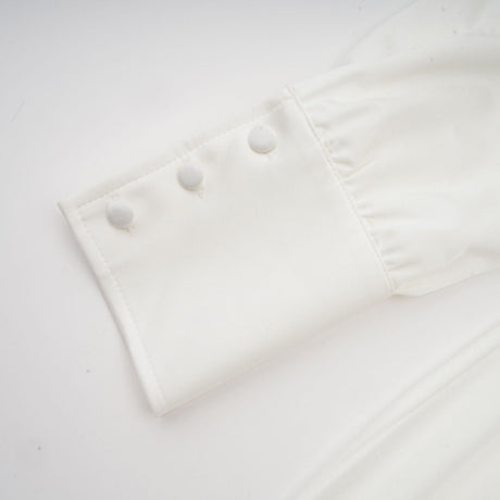 White mini dress with ruched detailing and faux flower embellishments called Maeva