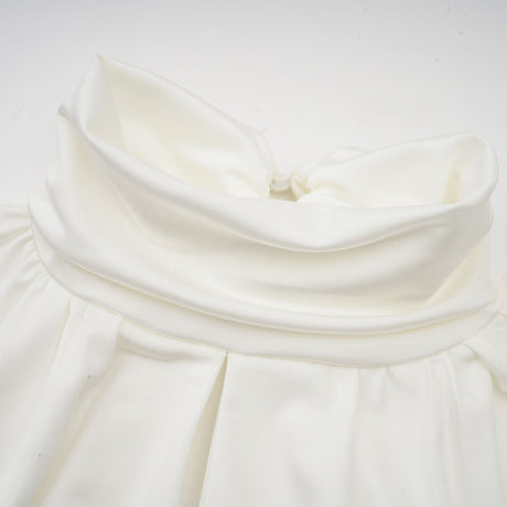 White mini dress with ruched detailing and faux flower embellishments called Maeva
