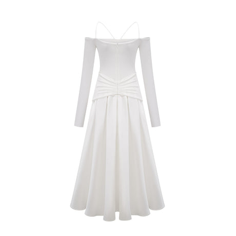 White offshoulder maxi dress with panels worn by model standing against plain background