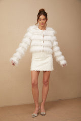 White padded fur jacket with crystal embellishments and a collarless design
