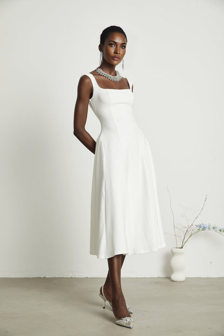 White pleated midi dress with flared skirt named Thala