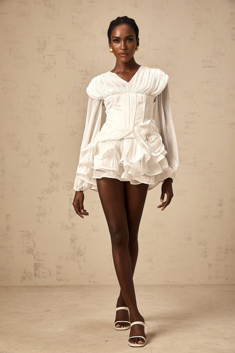 White pleated mini dress with cinched waist and full skirt