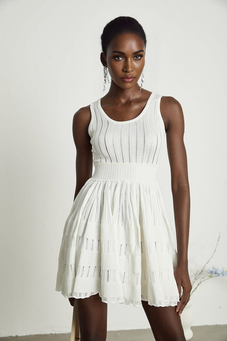 White pleated mini dress with cutouts by Noemie