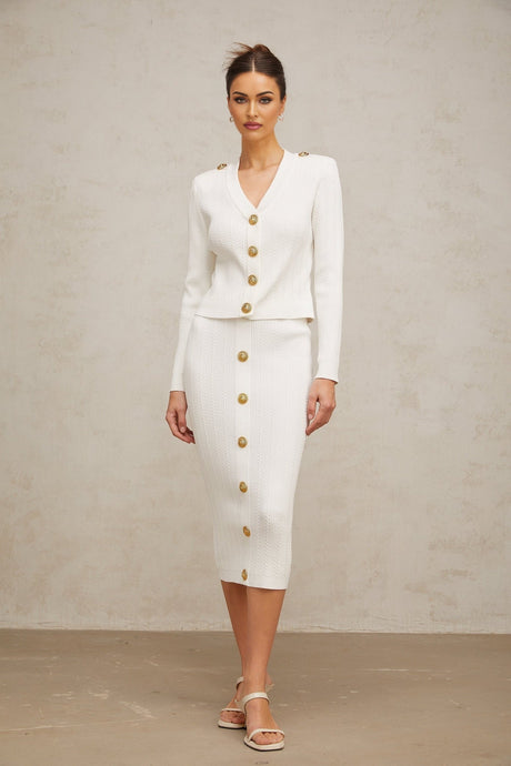 White ribbed knit jacket and skirt set featuring a coordinated design with matching textures and color