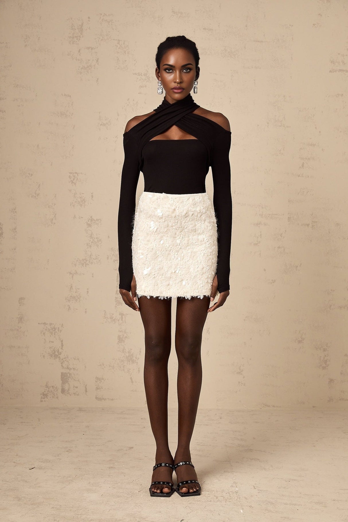 White sequined mini skirt with shimmering texture and short length