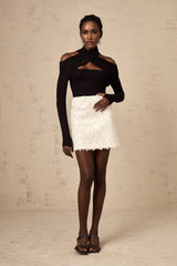 White sequined mini skirt with shimmering texture and short length