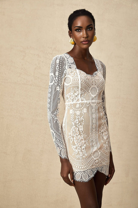 White short lace dress with scalloped hem and delicate floral pattern