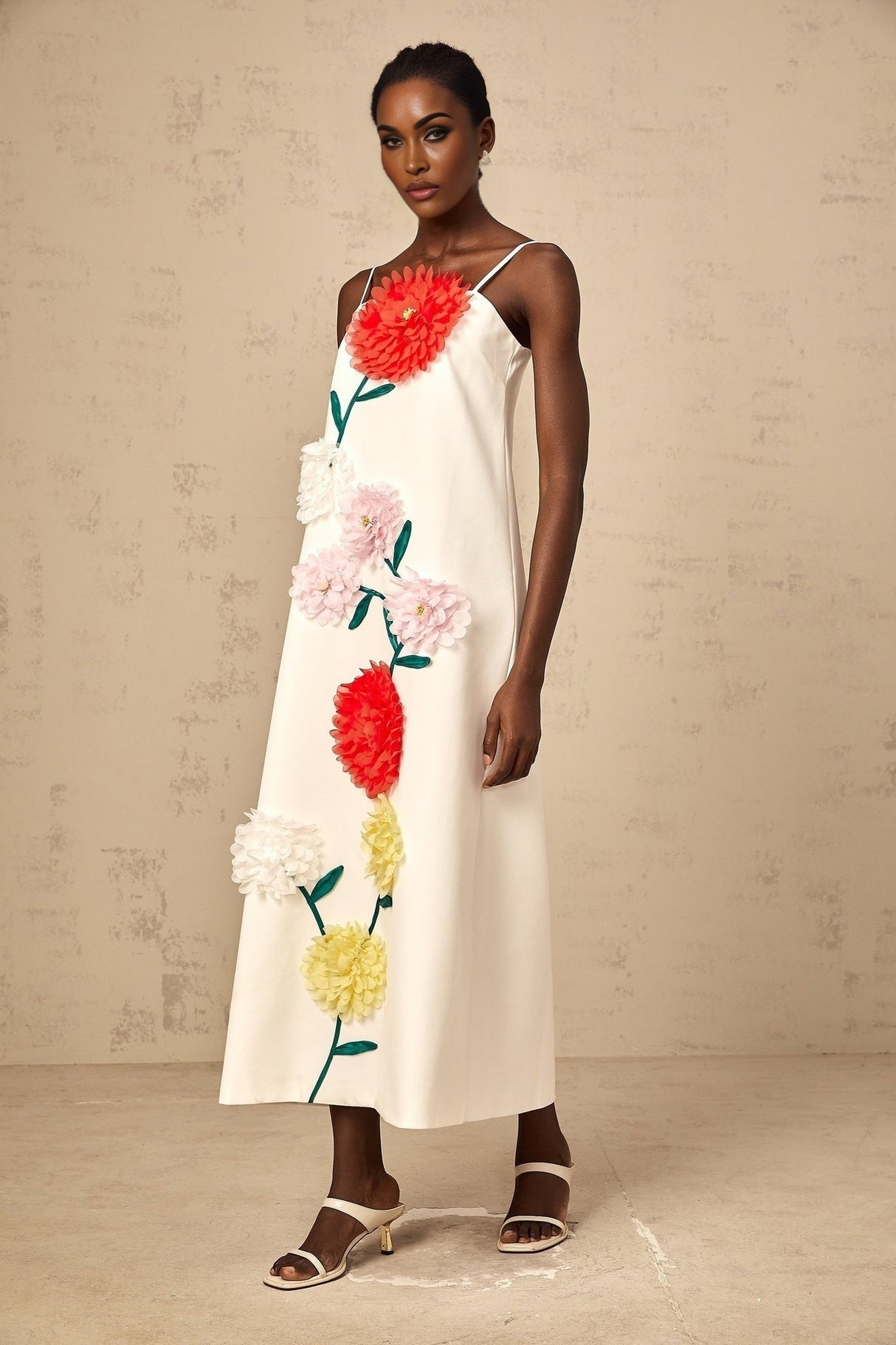 White sleeveless midi dress with three dimensional petal details on the bodice