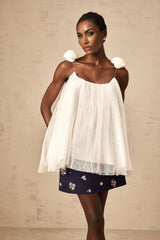 White sleeveless top with floral applique details on sheer mesh fabric
