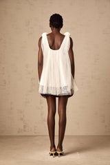 White sleeveless top with floral mesh overlay and flower appliques