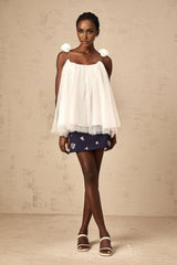 White sleeveless top with floral mesh overlay and flower appliques