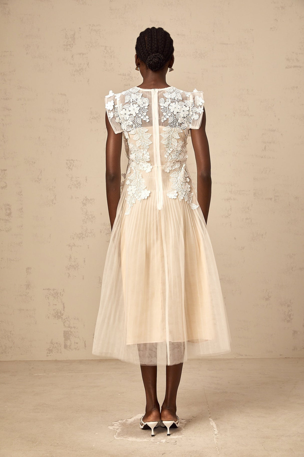 White tulle midi dress with colorful floral appliques scattered across the bodice and skirt
