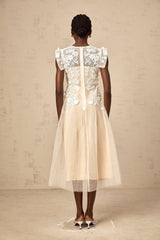 White tulle midi dress with colorful floral appliques scattered across the bodice and skirt