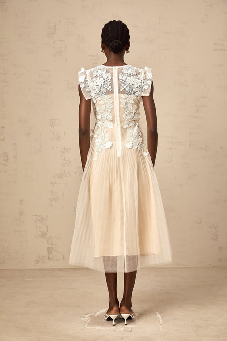White tulle midi dress with colorful floral appliques scattered across the bodice and skirt