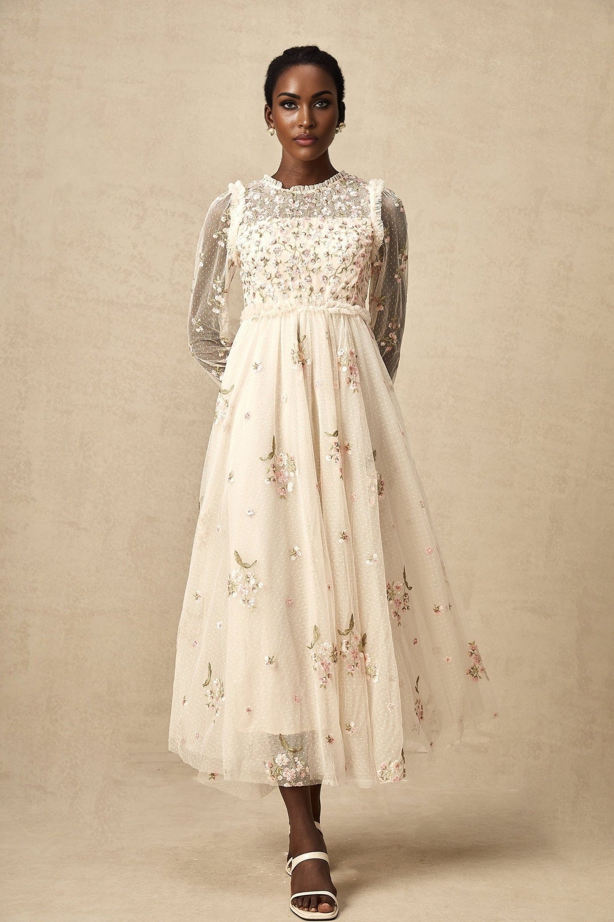 White tulle midi dress with colorful floral embroidery by Celine featuring sheer sleeves and delicate floral patterns throughout the bodice and skirt