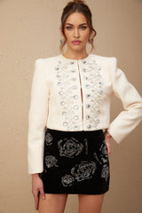 White tweed jacket adorned with crystal embellishments featuring Nerina design