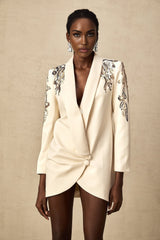 Woman wearing a black blazer dress with sequin embellishments