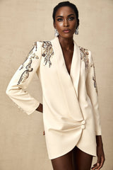 Woman wearing a black blazer dress with sequin embellishments