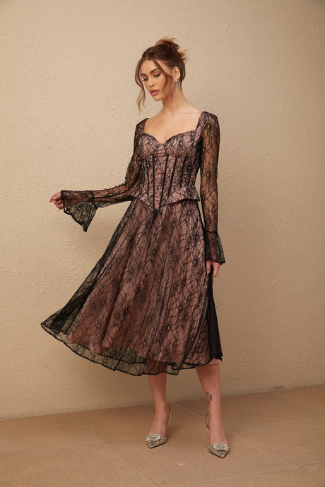 Woman wearing a black lace midi dress with flared skirt and form fitting bodice