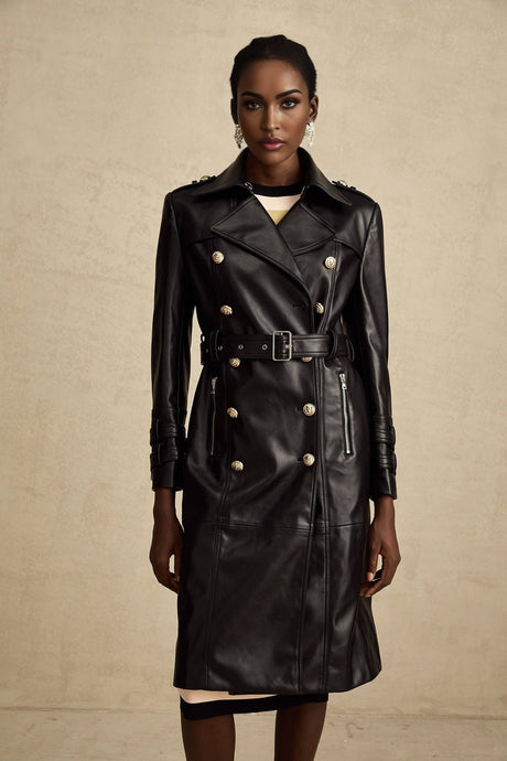 Woman wearing a black leather coat with doublebreasted front closure and belt at waist