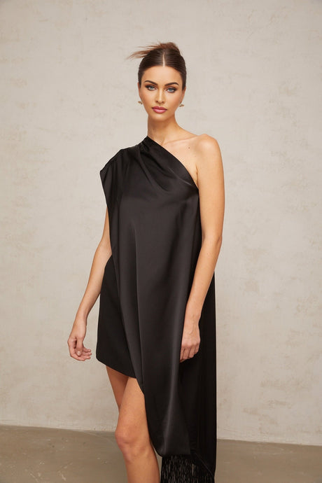 Woman wearing a black oneshoulder mini dress suitable for Valentines Day occasion
