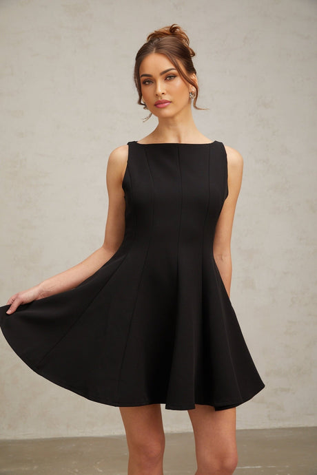 Woman wearing a black sleeveless mini dress with a flared skirt