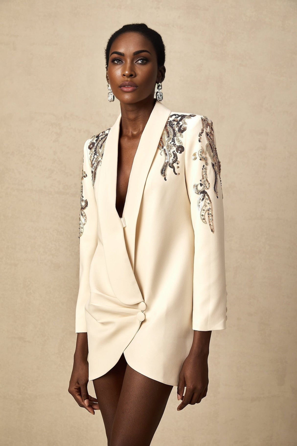 Woman wearing a blazer dress with sparkly sequin embellishments