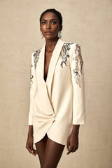 Woman wearing a blazer dress with sparkly sequin embellishments