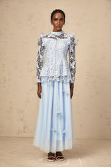 Woman wearing a blue sequined lace top and matching skirt set called Nicolette