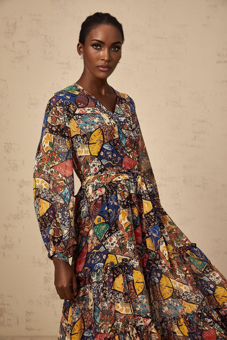Woman wearing a brown bohemian style midi dress with shirring detail and flowing fabric